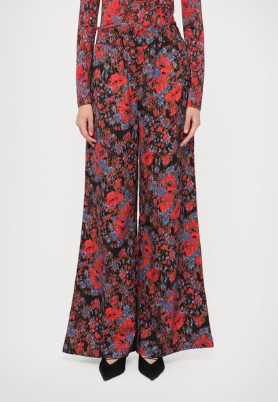 Floral wide-leg trousers in black fabric, featuring a vibrant red and blue flower pattern. Smooth texture with an elastic waistband.