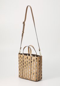 Handtas van tanleer met uitgesneden rechthoekige patronen, langwerpige vorm, dubbele bovenhandvatten en een verstelbare schouderriem.