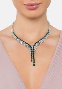 Emerald and clear crystal necklace featuring a Y-shaped design with pear-shaped stones cascading from the center.  Silver metal accents.