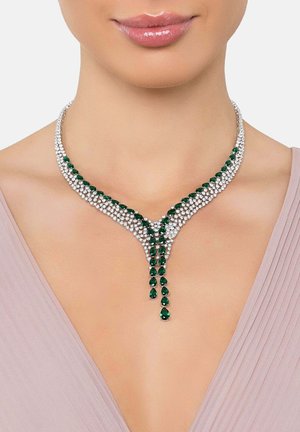 Emerald and clear crystal necklace featuring a Y-shaped design with pear-shaped stones cascading from the center.  Silver metal accents.
