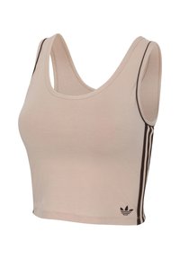 Débardeur court beige avec logo trefoil Adidas noir et trois bandes noires sur les côtés, sans manches avec larges bretelles.