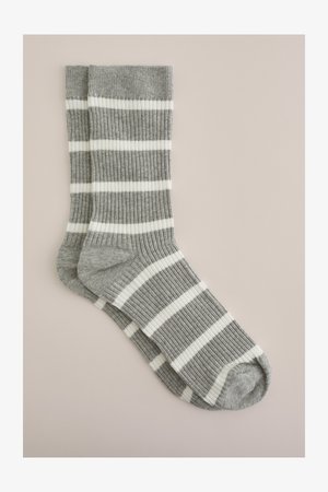 Gray and white striped socks with a ribbed texture, featuring alternating thick and thin horizontal stripes.