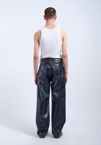 Dark blue faux leather wide-leg pants with a smooth texture, featuring two back pockets and a label at the waistband.