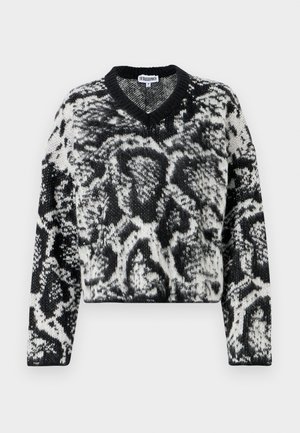 Pull cropped noir et blanc avec un col en V, présentant un motif texturé de print animal et des manches longues. Matière en tricot doux.
