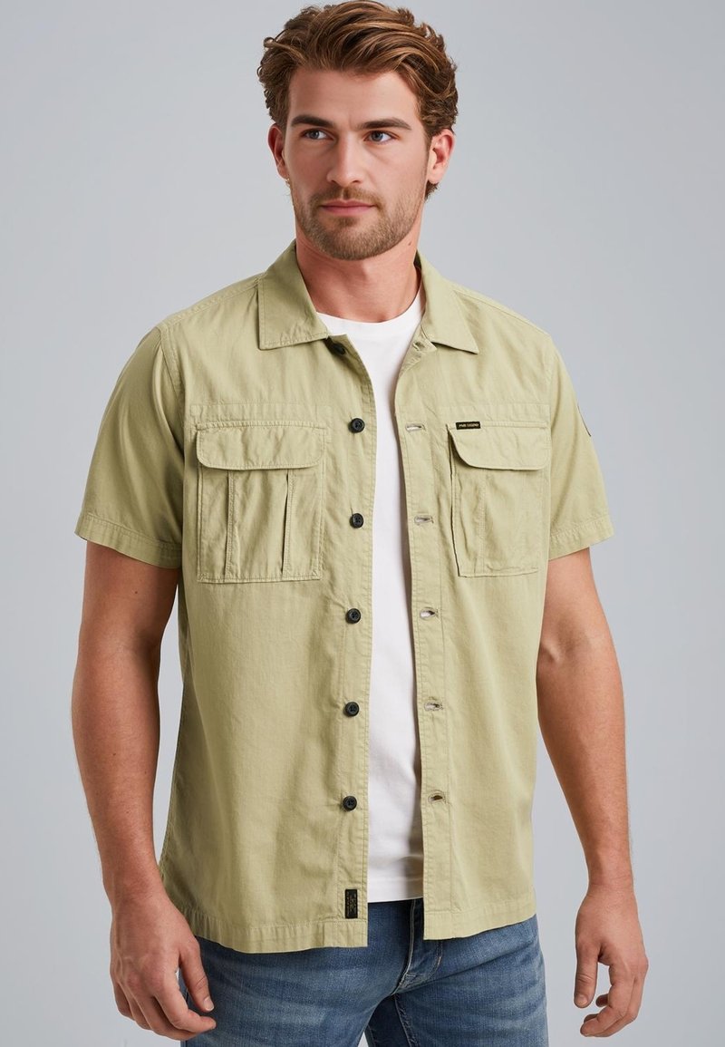 Short-sleeve shirt in light green, made of fabric with a smooth texture. Features two chest pockets, a button front, and a collar.
