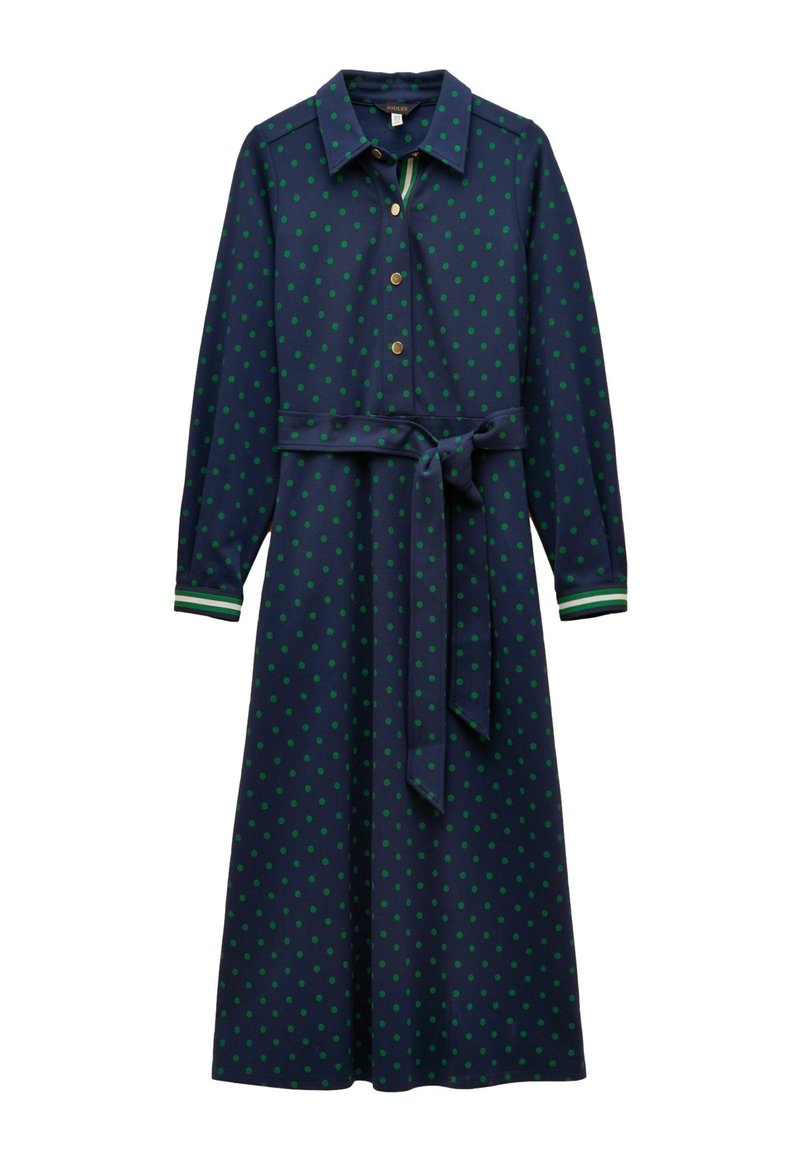 Tumši zila kleita ar zaļām polka punktiem, apkakle, pogu priekšpuse, garas piedurknes, auduma josta un svītraini akcenti uz piedurknēm.