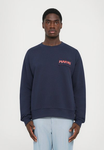 Felpa blu navy con collo rotondo e maniche lunghe, caratterizzata da una tasca quadrata con il testo rosso "MARNI" ricamato su di essa.