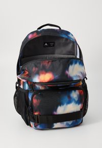 Multi-colored backpack featuring abstract cloud patterns, durable fabric, multiple zippered compartments, and a top carry handle.