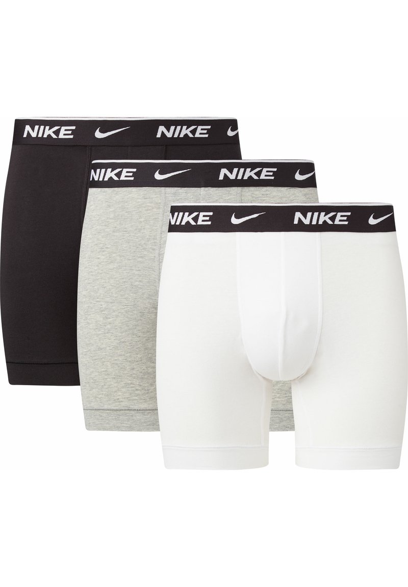 Tre par Nike boxerkalsonger i svart, grått och vitt. Varje par har en svart elastisk midjeband med "NIKE" i vit text. Materialet är en bomullsblandning.