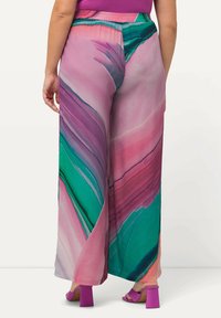 Bredde bukser i let stof med et farverigt abstrakt mønster i pink, grøn og lilla, med elastisk talje.