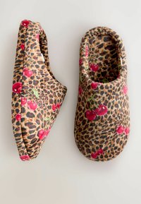 Leopard print slippers featuring red cherry accents, made of soft fabric, with a rounded shape and padded interior for comfort.