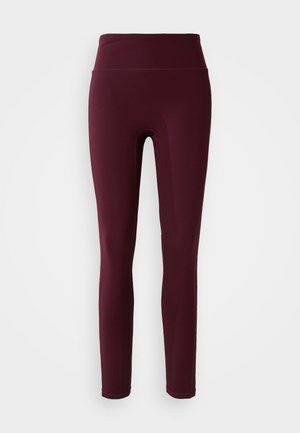 Leggings bordeaux con vita alta, realizzati in tessuto elasticizzato, caratterizzati da una texture liscia e un design aderente. Nessun motivo o dettaglio visibile.