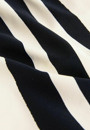 Juodas ir grietinėlės spalvos dryžuotas audinys su lygiu paviršiumi, rodomas drąsiomis horizontaliosiomis linijomis lengvesnio atspalvio fone.