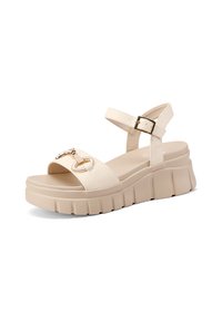 Sandali platform beige con una larga fascia, fibbia regolabile alla caviglia e dettagli decorativi in oro. Suola testurizzata con scanalature pronunciate.