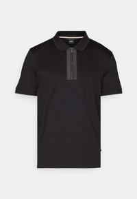 Polo noir en coton lisse, avec une fermeture éclair sur le plastron et un panneau contrastant, des manches courtes et un col classique.