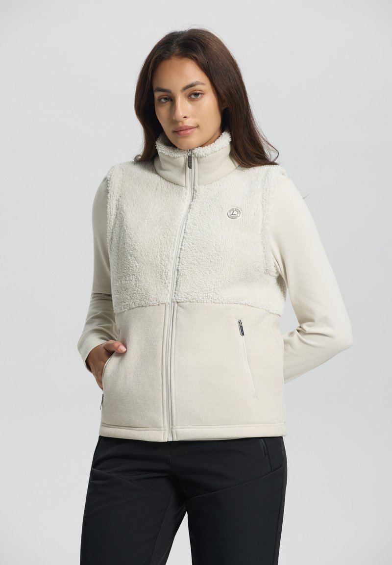 Ljusbeige zip-up väst med en strukturerad fleeceövre och en slät nedre del. Har en hög krage och två sidofickor.