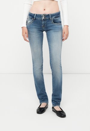 Light blue denim jeans with a straight fit, two front pockets, and visible stitching details. Worn with black flat shoes.