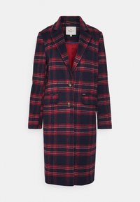 Navy sininen ja punainen ruudullinen villakangas takki, jossa on viistetyt lapelit, kaksi nappia, läppätaskut ja punainen vuori.