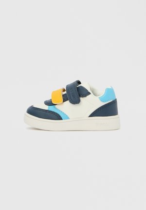 Sneaker featuring a mix of navy blue, light blue, and yellow accents on a white base, with Velcro straps and a rubber sole.