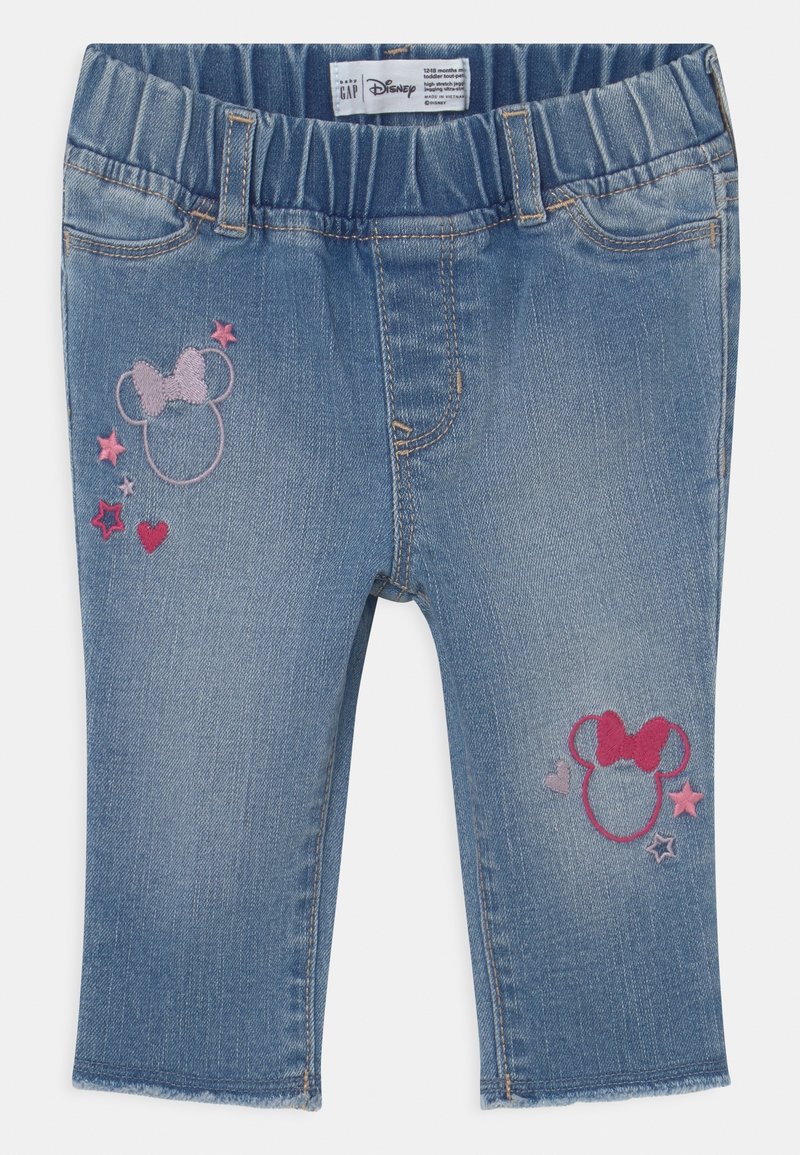 Jeans bleu pour tout-petit avec taille élastique et tête de Minnie brodée en rose, étoiles et décorations en forme de cœur sur les jambes avant.