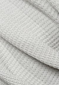 Gorro gris de punto con una textura suave, un puño acanalado y una parte superior lisa con un patrón tejido.