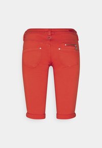Red denim knee-length shorts with a rolled hem, featuring two back pockets and a zippered pocket on the right side. Silver hardware accents.