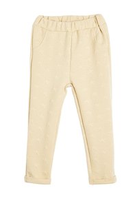 Beige Hose mit strukturiertem Sternmuster, elastischem Bund, zwei seitlichen Taschen und umgekrempelten Säumen. Weiches Material.