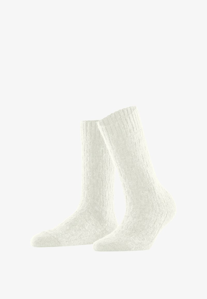 Białe skarpetki dziane z teksturowanym wzorem, sięgające do połowy łydki, z ściągaczem dla pewnego dopasowania i miękkim, puszystym materiałem.