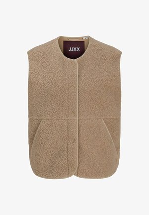 Beige fleecepaita, jossa pehmeä tekstuuri, pyöreä pääntie, edessä napit ja kaksi sivutaskua. Reunukset samansävyisestä beigestä kankaasta.