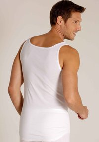 White cotton tank top featuring a round neckline and a fitted design. Smooth texture with no patterns or accents. Back view shown.