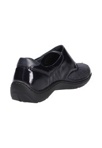 Scarpa nera in pelle con tomaia testurizzata, tacco liscio e suola di gomma. Design slip-on con punta arrotondata e dettagli di cucitura minimi.