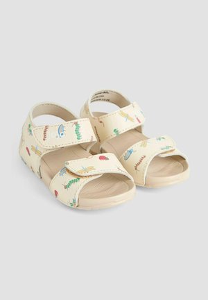 Svetlo rjave sandale z barvitimi vzorci insektov, opremljene z dvema nastavljivima Velcro trakovoma in teksturiranim podplatom za boljši oprijem. Lahka material.