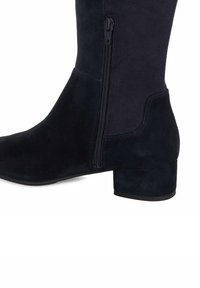 Navy ankle boot with a suede finish, featuring a side zipper, a block heel, and a smooth texture. Designed for easy wear and comfort.
