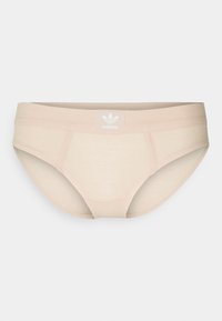 Bañador beige de canalé hecho de un tejido elástico. Cuenta con una cinturilla elástica con una pequeña etiqueta blanca de Adidas en la parte delantera.
