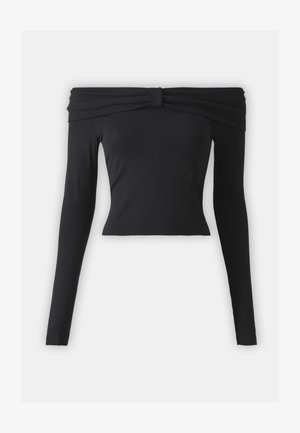 Juodas, ilgomis rankovėmis, be petnešų viršus su mazgu. Tinkantis figūrai, pagamintas iš lygaus audinio su trumpa siluetu. Paprastas ir monochrominis dizainas.