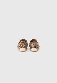 Leopard print slip-on shoes with a soft fabric upper, rounded toe, and contrasting light-colored rubber sole.