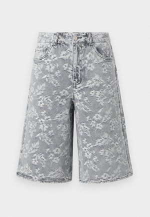 Kõrge vöökohaga põlveni ulatuvad teksapüksid, millel on helehall lillemuster, ees nööpide ja tõmblukuga kinnitus ning kaks esitaskut.