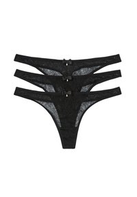 String in pizzo nero, in tre paia con motivi floreali, cinture sottili, piccoli dettagli a fiocco e un pendente sul retro.