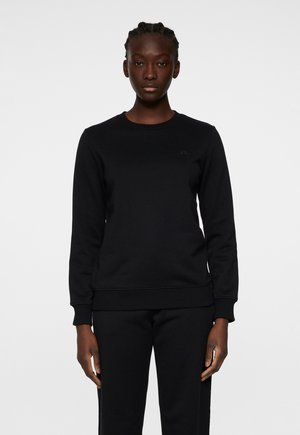 Sort sweatshirt med rund hals, lange ærmer og ribbede manchetter. Fremstillet af tekstureret stof, med et diskret logo på brystet.