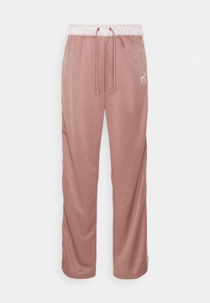 Pink sweatpants made of soft fabric, featuring an elastic waistband with drawstrings, and a small white logo on the left side.