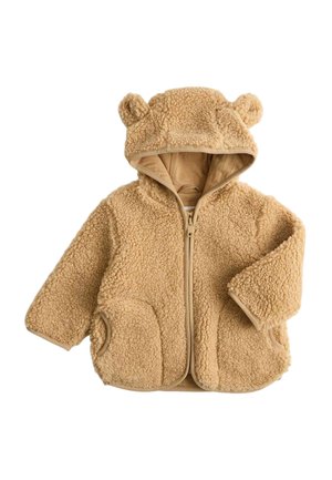 Soft tan-colored toddler jacket with hood featuring bear ears and two front pockets, made of fluffy teddy fleece material.