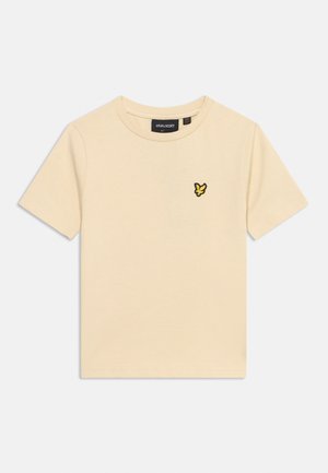 Tricou bej cu mâneci scurte și guler rotund, având un mic logo cu o pasăre galbenă și neagră pe pieptul stâng.