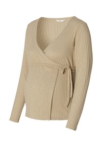 Beige ribbad wrap-top med långa ärmar, knyts i midjan och har V-ringning. Tillverkad av mjukt, strukturerat tyg som är designat för komfort.