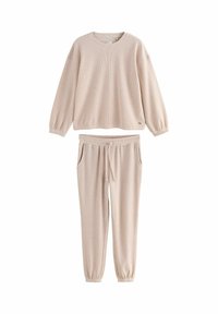 Ljusbeige ribbad lounge-set bestående av en tröja med rundad halsringning och elastiska ärmmuddar samt byxor med dragsko och sidofickor.