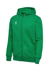 Sweat à capuche zippé vert avec poches frontales, capuche avec cordon et logo blanc Hummel sur la poitrine gauche.
