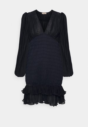 Black dress with long sleeves, pleated texture, V-neckline, smocked waist, and ruffled hem. Lightweight fabric with intricate lace accents.