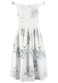 Robe blanche avec un design décolleté, motif floral en nuances de bleu et vert, tissu texturé et jupe évasée plissée.