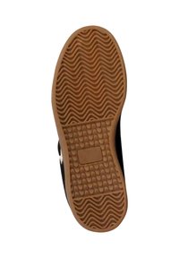 Suela de zapato de goma con una textura ondulada, de color marrón. El diseño incluye un agarre con patrón para tracción y un borde suave.