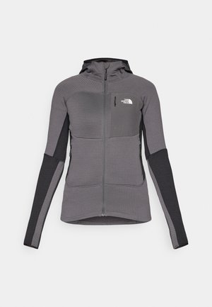 Gray zip-up jacket with a hood, ribbed texture, black accents on sleeves, and a small chest pocket. Displayed against a white background.
