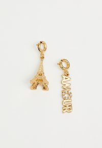 Gold-tone earrings feature a miniature Eiffel Tower charm and a charm that reads "AMOUR," accented with clear rhinestones.